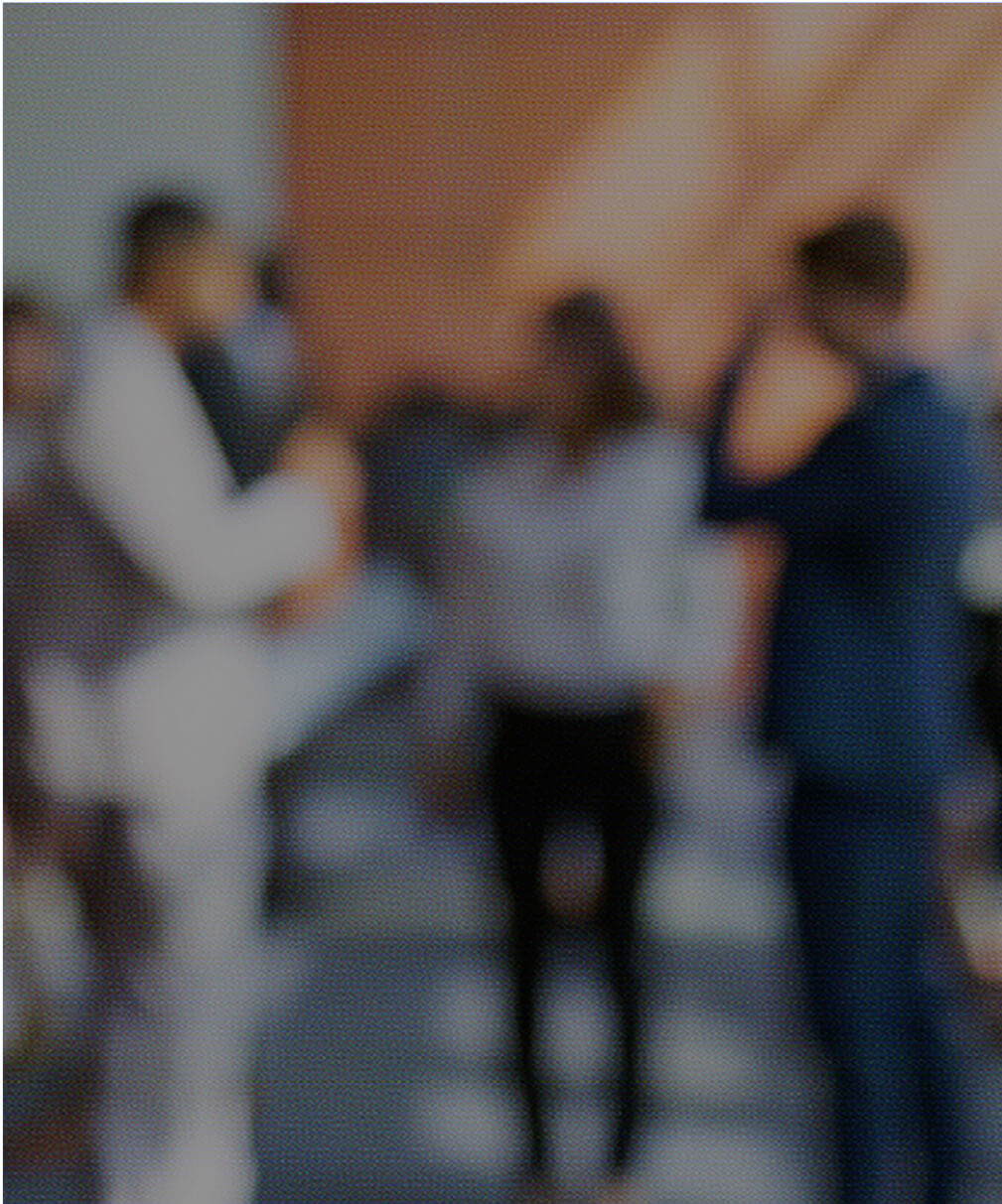 Blurred image of business professionals networking in an office, representing Calgary IT services teamwork and collaboration.