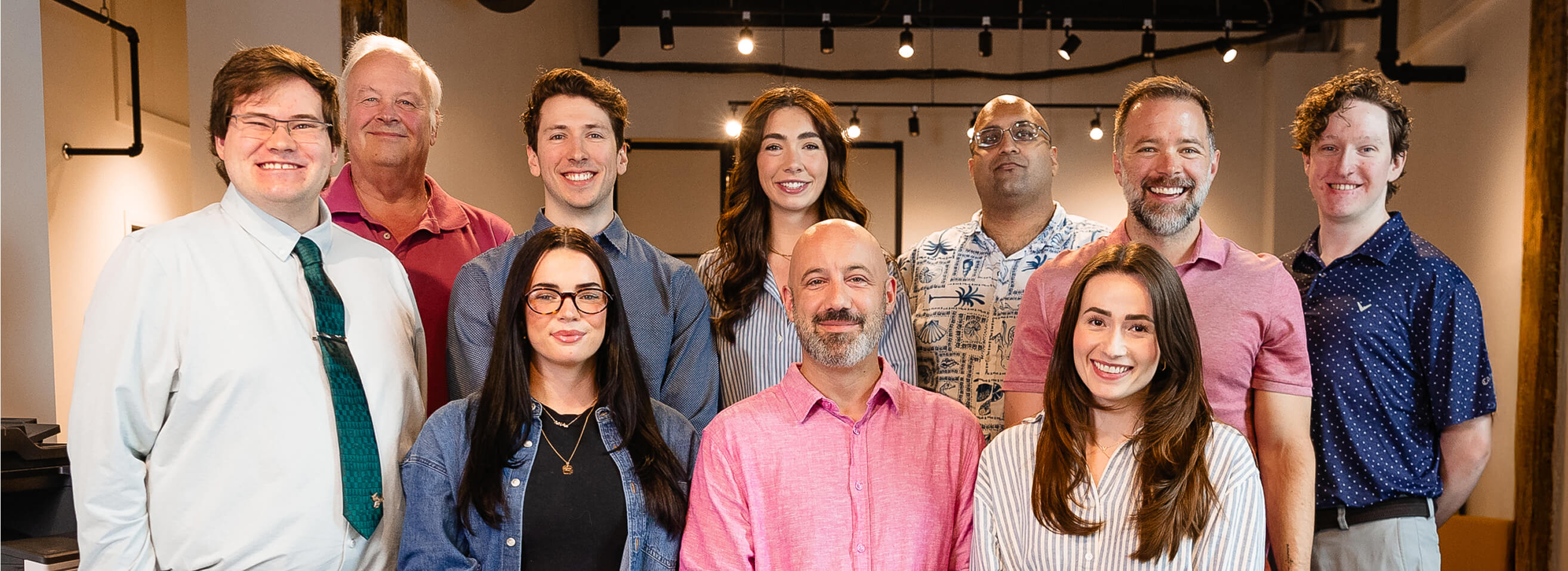 Group portrait of Always Beyond Technology Solutions team in a modern office, showcasing Calgary IT services professionals.